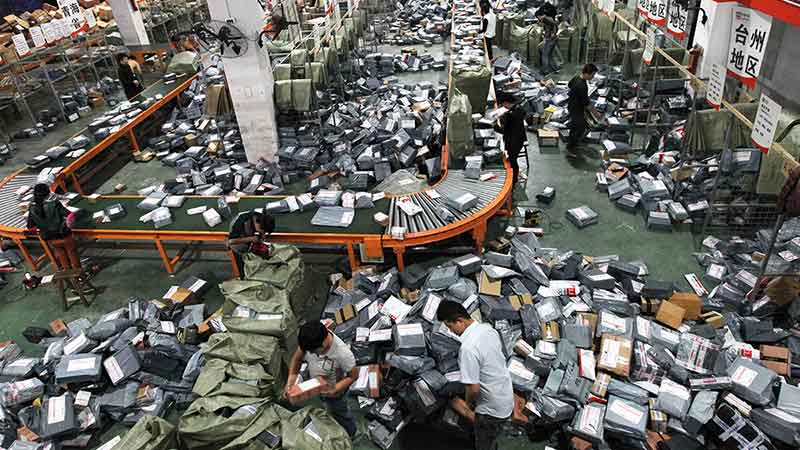 Postal workers struggle with an avalanche of Singles Day online purchases. Pic: Getty.