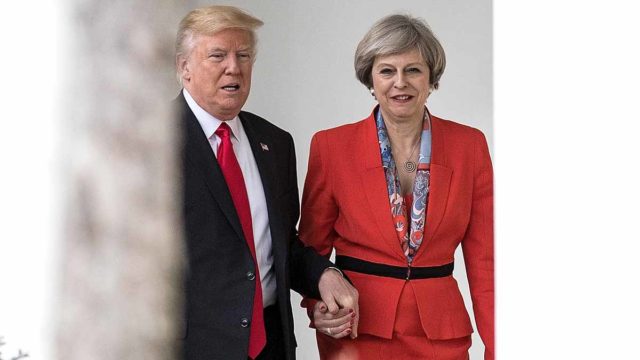 British PM Theresa May and President Donald Trump hold hands at The White House in January 2017. Pic: Getty
