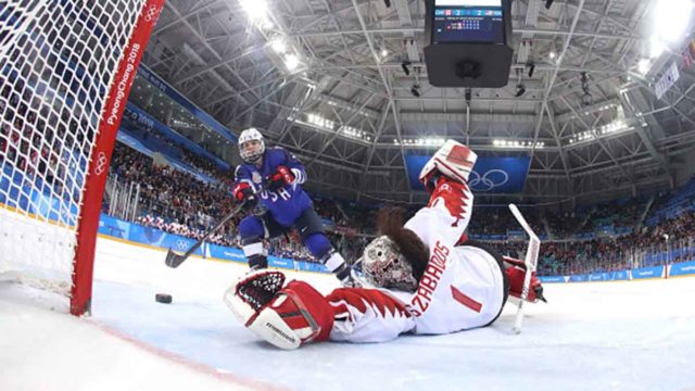 USA makes a shot at goal against Canada in the women's ice hockey final.