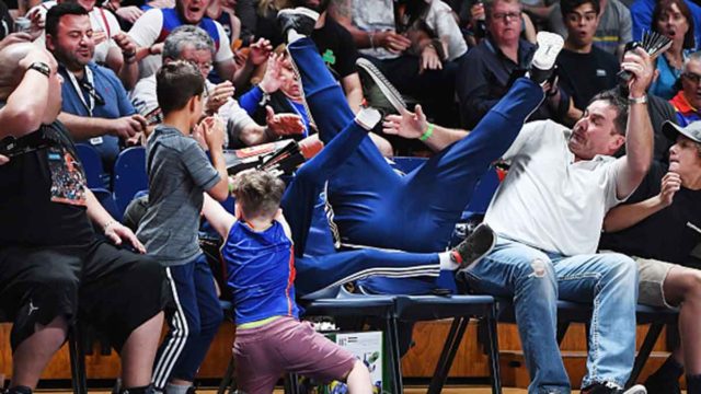 Mitch Creek of the Adelaide 36ers lands in the crowd chasing a pass during game four of the NBL Grand Final in Adelaide.