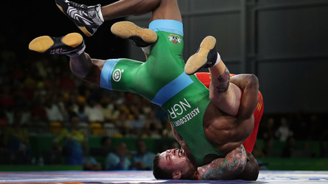 Wales's Curtis Dodge and Nigeria's Ebimienfaghe Assizecourt compete in the men's Freestyle
