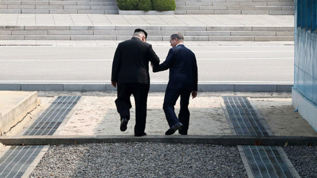 Kim Jong Un (L) takes hand of South Korean President Moon Jae-in (R) to cross the military demarcation line (MDL) to the north side upon meeting for the Inter-Korean Summit in Panmunjom, South Korea.
