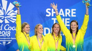 Australian female 4x100m Freestyle Relay team receive their medals on day one of the Commonwealth Games.