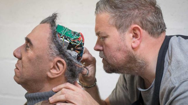 A prosthetic expert checks on Fred - a robot on display in Britain. Pic: Getty