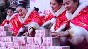 A table full of 100-yuan banknotes given away in a tourist promotion in Hangzhou, China last year. Pic: Getty