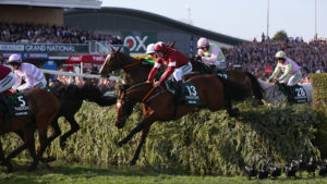 Tiger Roll ridden by Davy Russell (13) jump the Water Jump on their way to victory in the Randox Health Grand National Handicap Steeple Chase.