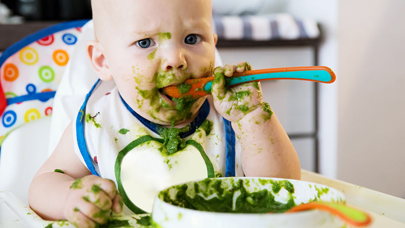 A baby eaing a very messy meal. Pic: Getty