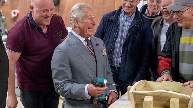 Prince Charles uses a power drill during a visit to a community centre in Northern Ireland yesterday. Pic: Getty