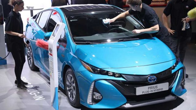 Workers buff a Toyota Prius plug-in hybrid at the 2017 Frankfurt Auto Show in September. Pic: Getty