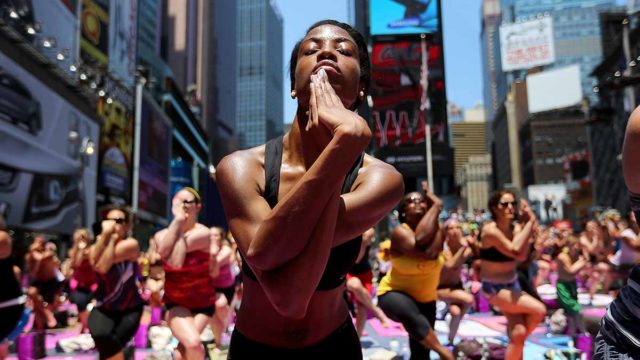 New Yorkers practise Yoga in Times Square to mark Summer Solstice. Pic: Getty