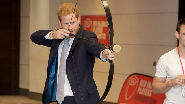 Prince Harry tries archery in London on Thursday. Pic: Getty