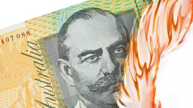 A $100 note on fire. Pic: Getty