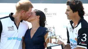 Prince Harry and Duchess Meghan share a kiss at the polo in Windsor, England on Thursday. Pic: Getty