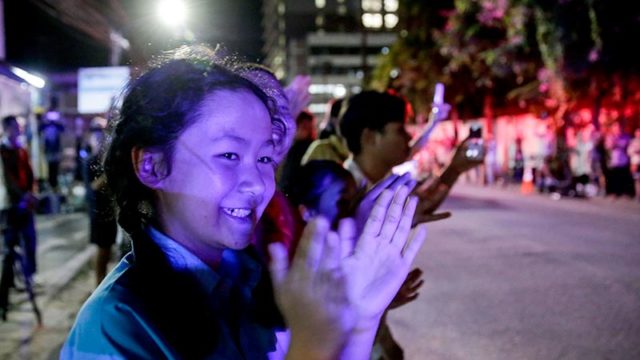 Onlookers cheer as the Thai soccer team is safely rescued from an underground cave and taken to hospital. Pic: Getty