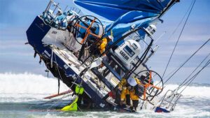 The crew of Team Vestas Wind try to right their stranded yacht in the 2014 Volvo Ocean Race. Pic: Getty