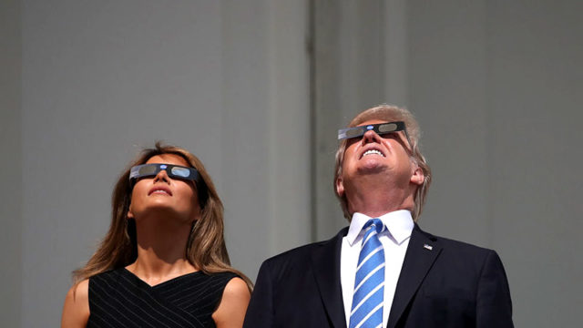 President Trump and first lady Melania view a solar eclipse at the White House in 2017. Pic: Getty