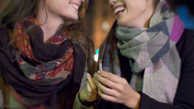 Cannabis: two people share a marijuana joint. Pic: Getty