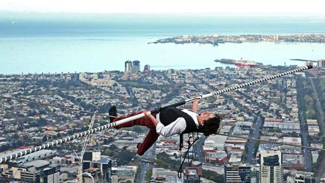 High-wire artist Kane Petersen walks a tightrope 300 metres above the ground in Melbourne, 2015. Pic: Getty