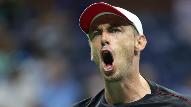 John Millman roars in delight as he upsets Roger Federer at the US Open. Pic: Alex Pantling/Getty