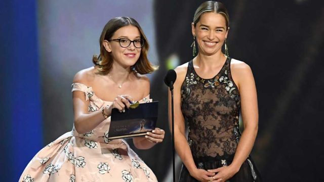Millie Bobby Brown (L) and Emilia Clarke speak onstage during the 70th Emmy Awards. Pic: Kevin Winter/Getty