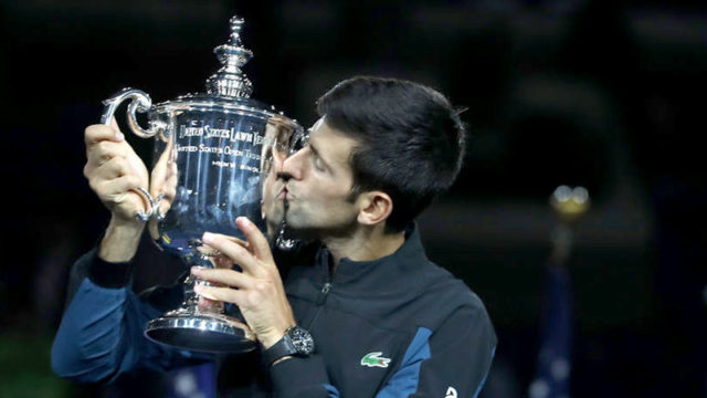 Novak Djokovic kisses the US Open trophy after winning his singles finals match today. Pic: Getty