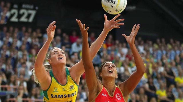 Aussie Caitlin Bassett of the Diamonds beats Brit Layla Guscoth to the ball in Australia's netball win over England in Newcastle last night. Pic: Getty