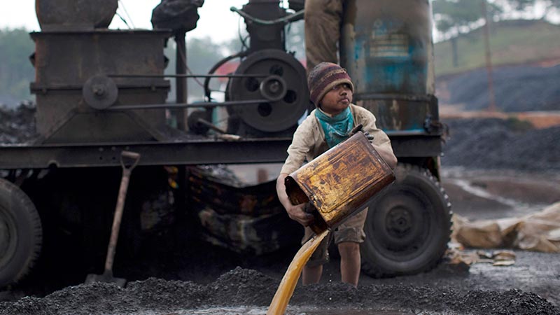 A boy works at a coal depot in Jaintia Hills, India in 2011. Pic: Getty