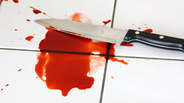 A bloody knife on a white tiled floor. Pic: Getty