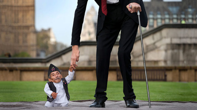 The world's shortest man Chandra Bahadur Dangi meets the world's tallest man Sultan Kosen in London in 2014. Pic: Getty