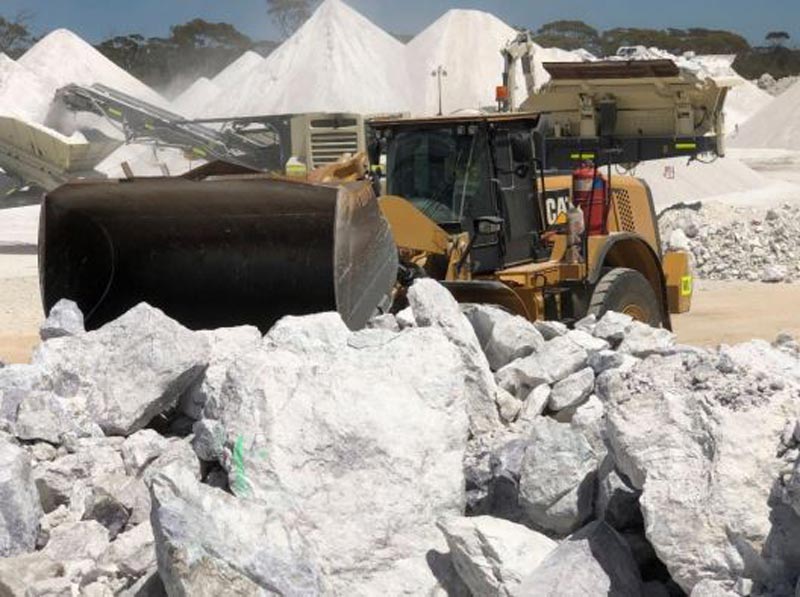 Crushing Pollucite: High grade pollucite in the foreground. In the background are the crushed ore stockpiles, each of approximately 1,200t. Pic: Pioneer Resources