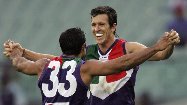 Matt Carr celebrates a goal with fellow Docker Jeff Farmer in 2006. Now he's hoping to kick goals with gold explorer Titan Minerals. Pic: Getty