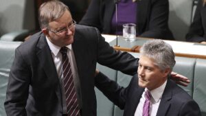 (Now former) Defence Minister Stephen Smith receives a pat on the back from (now former) Deputy Prime Minister Anthony Albanese after announcing he will not contest his seat in the upcoming election in the House of Representatives on June 27, 2013. Getty